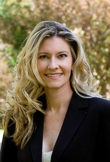 Dr. Rochelle Riley wearing a dark suit jacket against a nature background.
